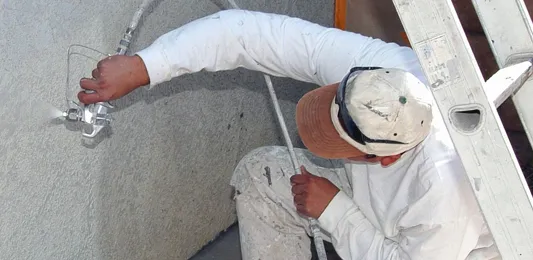 Painter painting commercial building